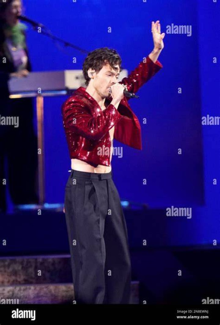 Harry Styles performing live on the stage.