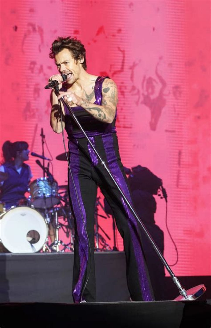 Harry Styles performing on the stage.