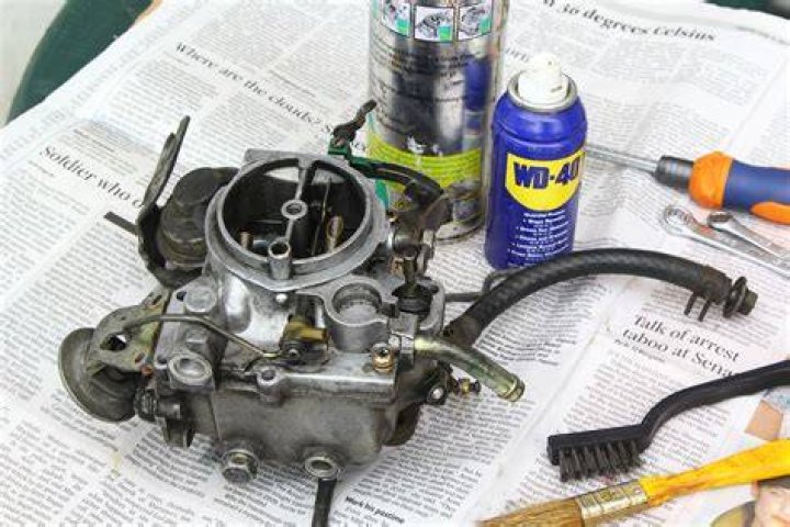 How do you clean a 2 stroke carburetor?