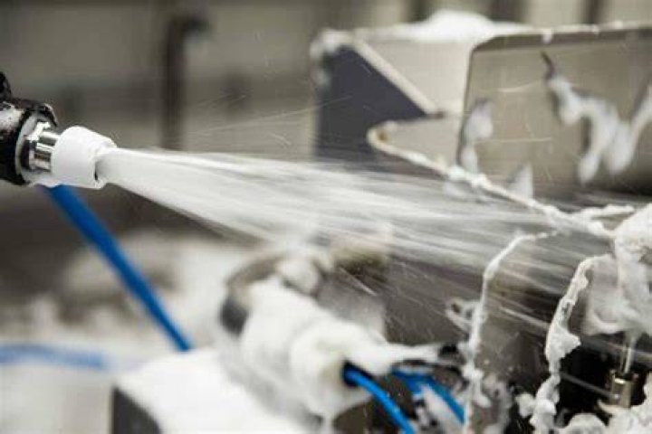 How do you clean spray foam nozzles?