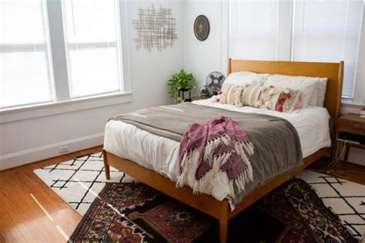 How do you put a throw on a bed?