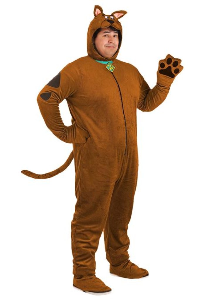 Human in Scooby costume is dancing whereas, Casey Kasam is smiling looking at him.